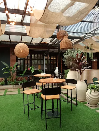 High tables in the garden area with woven pendant lights
