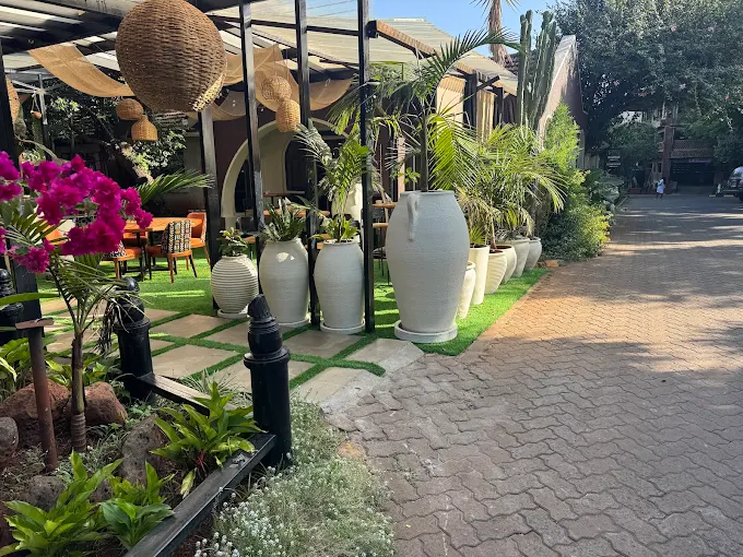 K'Osewe Westlands outdoor garden entrance with white ceramic pots