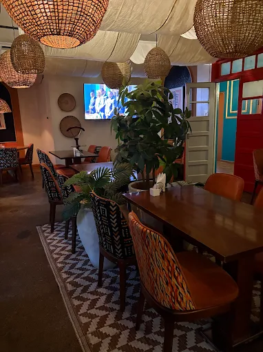 Interior dining room with African woven lights and kente chairs